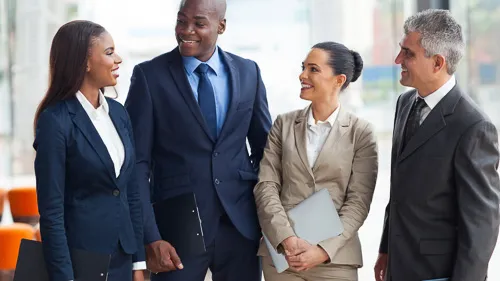 Four co-workers smiling together